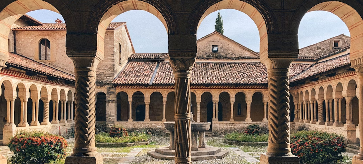 A Mediterranean courtyard with Blue skies and shrubbery 