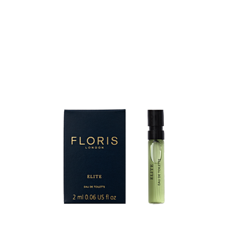 Small blue box and green vial labeled "Floris London Elite - Eau de Toilette 2 ml," offering a captivating woody fragrance.