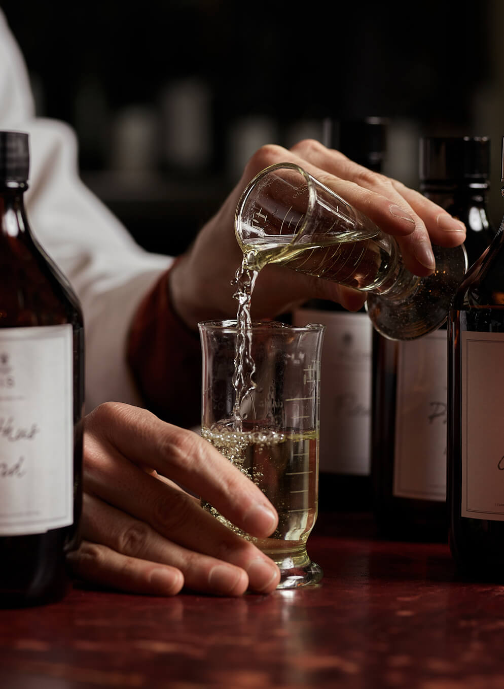 Pouring bespoke perfume into glass vial