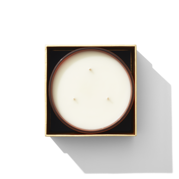 An open box with a candle inside, it has three wicks 