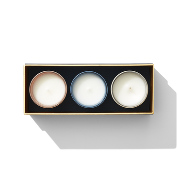an aerial view of three small candles. they are different colours. 