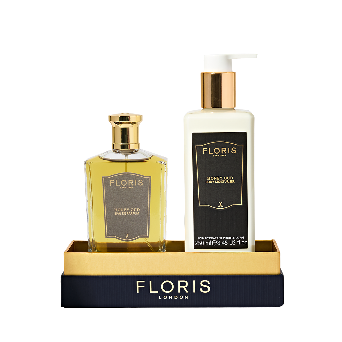 Floris London UK's Sweet Lux | Honey Oud Duo, featuring Eau de Parfum and Body Moisturiser, comes in luxe black and gold packaging on a matching tray.