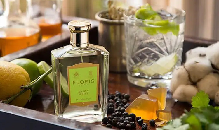 A tray with Floris London Jermyn Street Eau de Parfum, gin and fruits