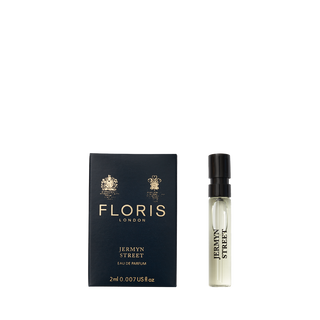 A 2ml vial of Floris London's Jermyn Street Eau de Parfum is elegantly displayed next to its sleek black and gold box.
