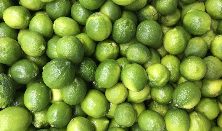A large amount of Limes piled on top of each other