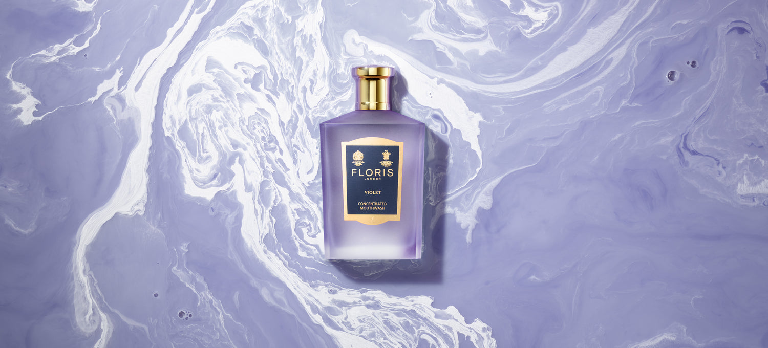 Bottle of Violet Floris London Mouthwash on a Purple and White swirled background