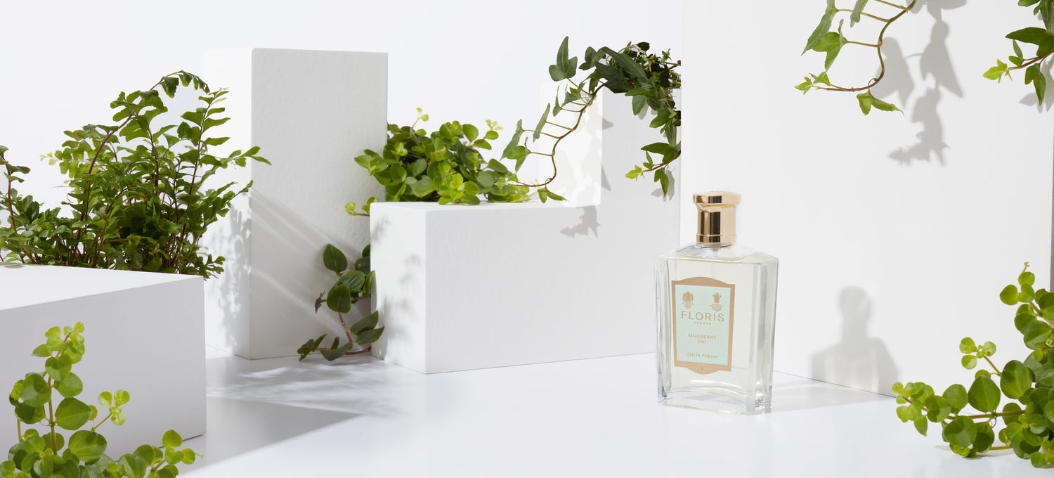 A bottle of Floris London Mulberry Fig with a green leafy background