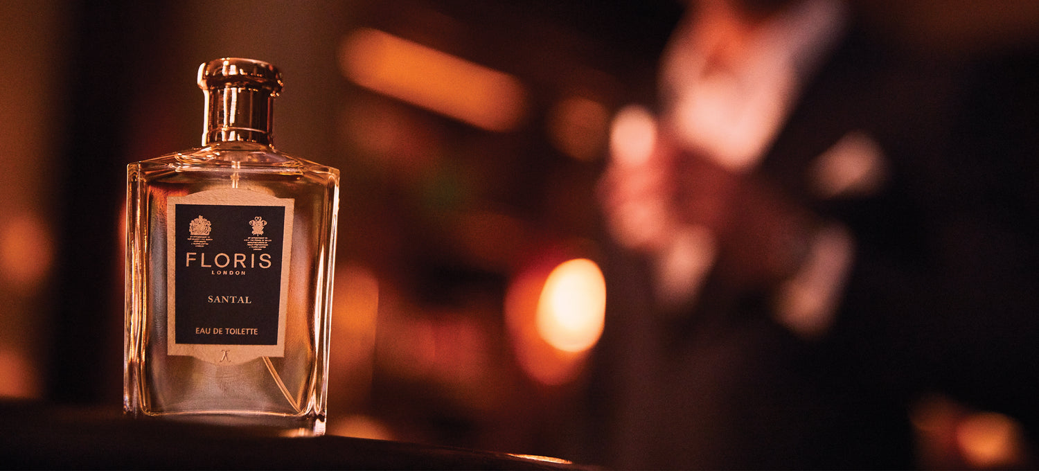 Santal Eau de Toilette and a blurred suited man in the background