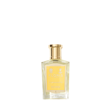 Clear glass bottle with gold cap containing Floris London Stephanotis - Bath Essence, featuring a floral fragrance and a yellow label.