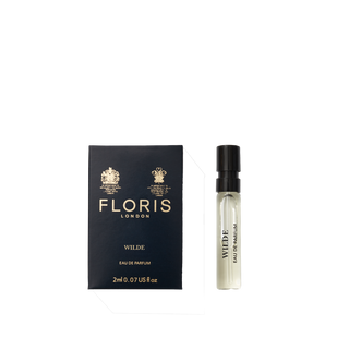 A deep blue box of Floris London Wilde - Eau de Parfum sits beside a small clear spray vial, representing freedom and individuality.