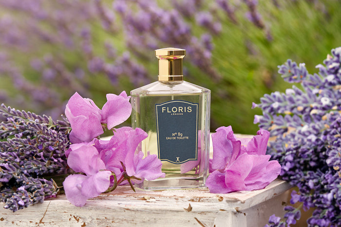 A bottle of Floris London No. 89 surrounded by lavender and sweet peas