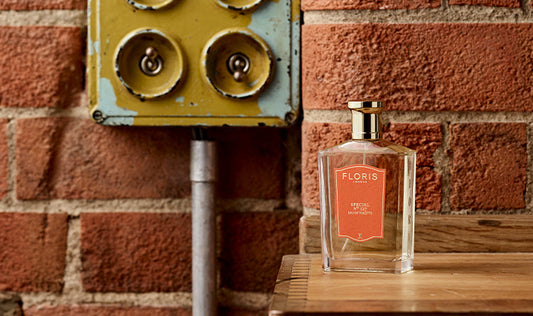 A bottle of Special No. 127 in front of a brick wall