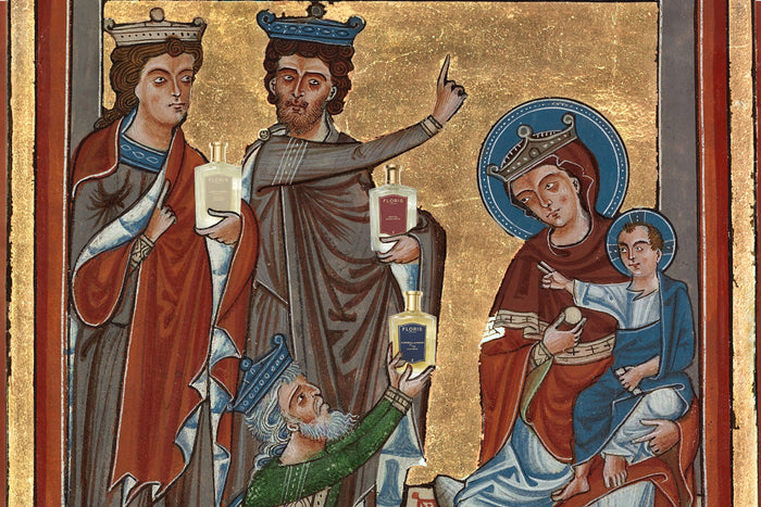 a painting of The Adoration of the Magi. With gold foli and deep, rich red tones the painting depicts the three wise men gifting Jesus fragrances from Floris London.