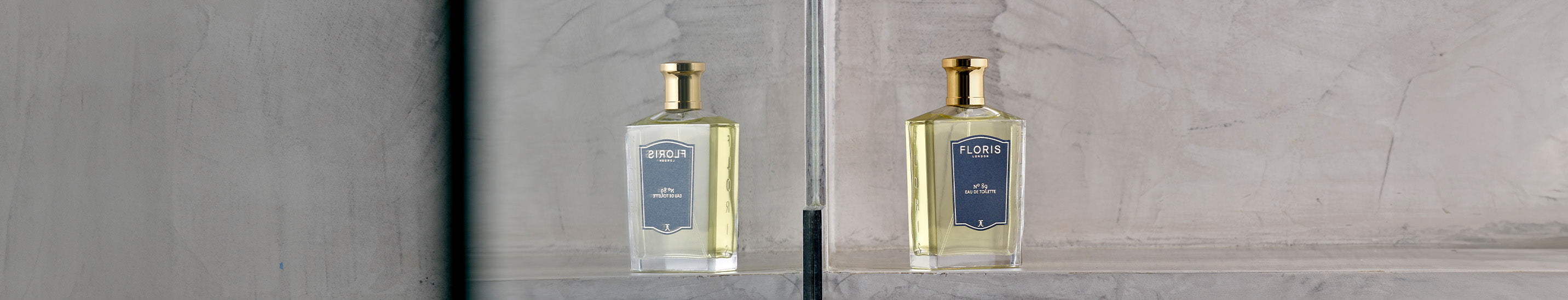 A glass fragrance bottle with a dark label, shown upright.