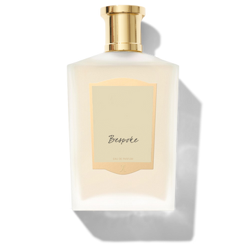 A white perfume bottle with a gold cap and a gold-bordered label reading "Floris London Bespoke Eau de Parfum," highlighting the fragrance's customisations.