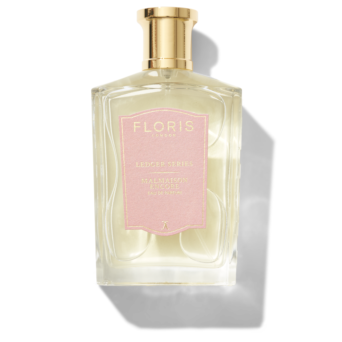 Large bottle of fragrance with a pink label saying Malmaison Encore