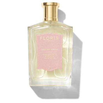 Large bottle of fragrance with a pink label saying Malmaison Encore