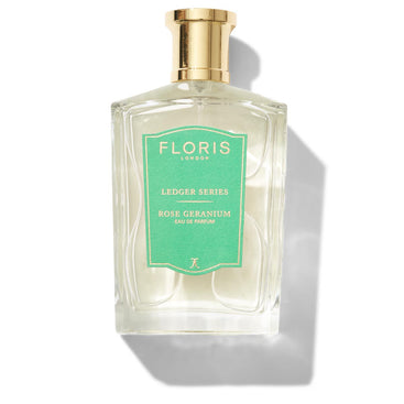 Large bottle of fragrance with a green label saying Rose Geranium