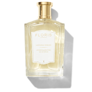 Large bottle of fragrance with a white label saying Stephanotis