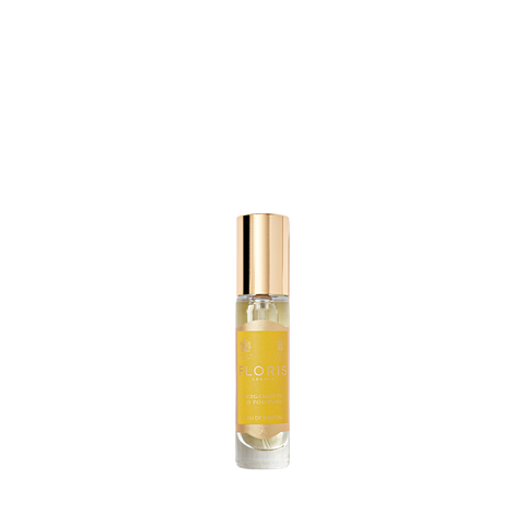 Clear glass bottle with a gold cap and a yellow label reads "Floris London," exuding an elegant fragrance of orange blossom. Product: Bergamotto di Positano.