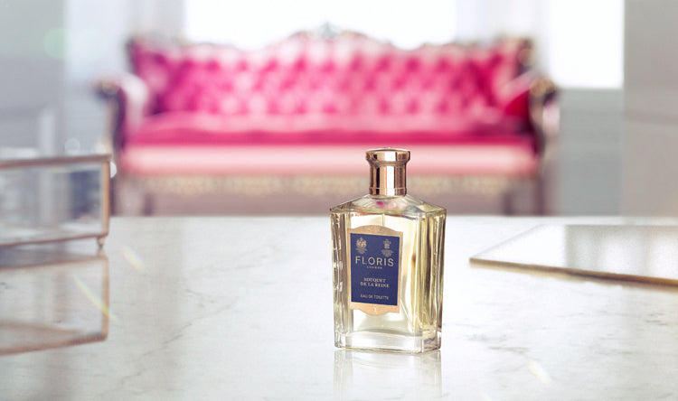 A pink seat blurred in the background with a bottle of Floris London bouquet De La Reine in the forefront