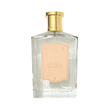 Clear glass perfume bottle by Floris London, gold cap, pink "Bouquet de La Reine" label; offers a fruity floral effervescence.