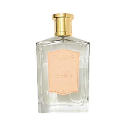 Clear glass perfume bottle by Floris London, gold cap, pink "Bouquet de La Reine" label; offers a fruity floral effervescence.