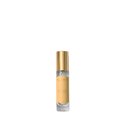 A small bottle of Floris London Bouquet de La Reine Eau de Toilette with a gold cap and beige label on a white background, offering fruity floral notes.