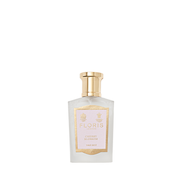 Floris London's Cherry Blossom Hair Mist 50ml comes in a clear glass bottle with gold cap and label, enriched with Panthenol Pro-Vitamin B5.