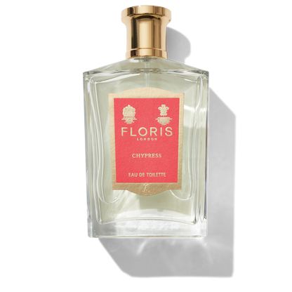 Clear glass bottle with gold spray top and Red Chypress label
