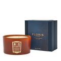 The Cinnamon & Tangerine Deluxe Three Wick Candle by Floris London, in a blue box, fills any space with a warm and inviting aroma.