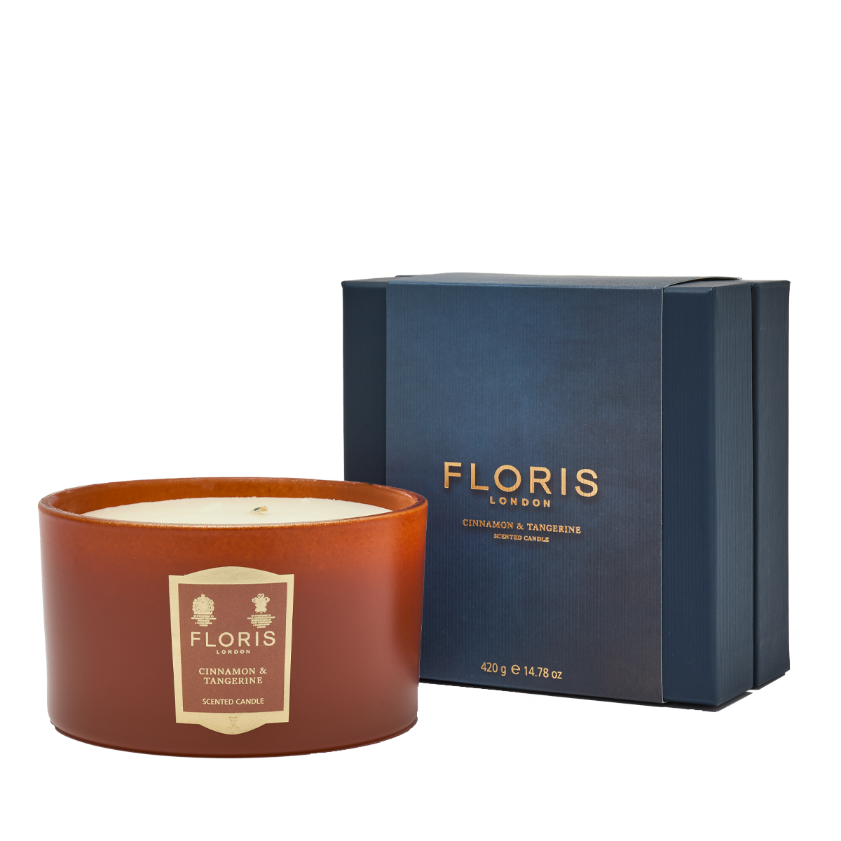 The Cinnamon & Tangerine Deluxe Three Wick Candle by Floris London, in a blue box, fills any space with a warm and inviting aroma.