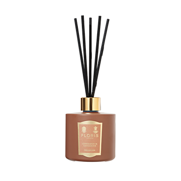 Floris London Cinnamon & Tangerine Reed Diffuser features a brown bottle with black reeds and gold label, offering a rich, room-filling fragrance.