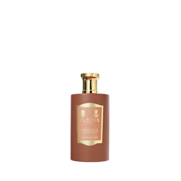 A bottle of Floris London Cinnamon & Tangerine Room Fragrance with a gold cap and label, featuring a rich spice blend of amber sandalwood.