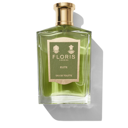 Clear glass bottle with gold spray top and Green Elite label