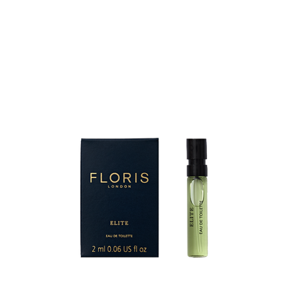 Small blue box and green vial labeled "Floris London Elite - Eau de Toilette 2 ml," offering a captivating woody fragrance.