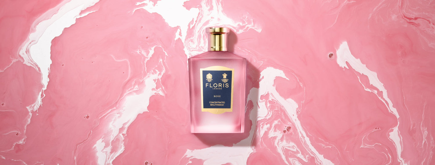 Bottle of Floris London Rose Mouthwash on a White and Pink swirled background