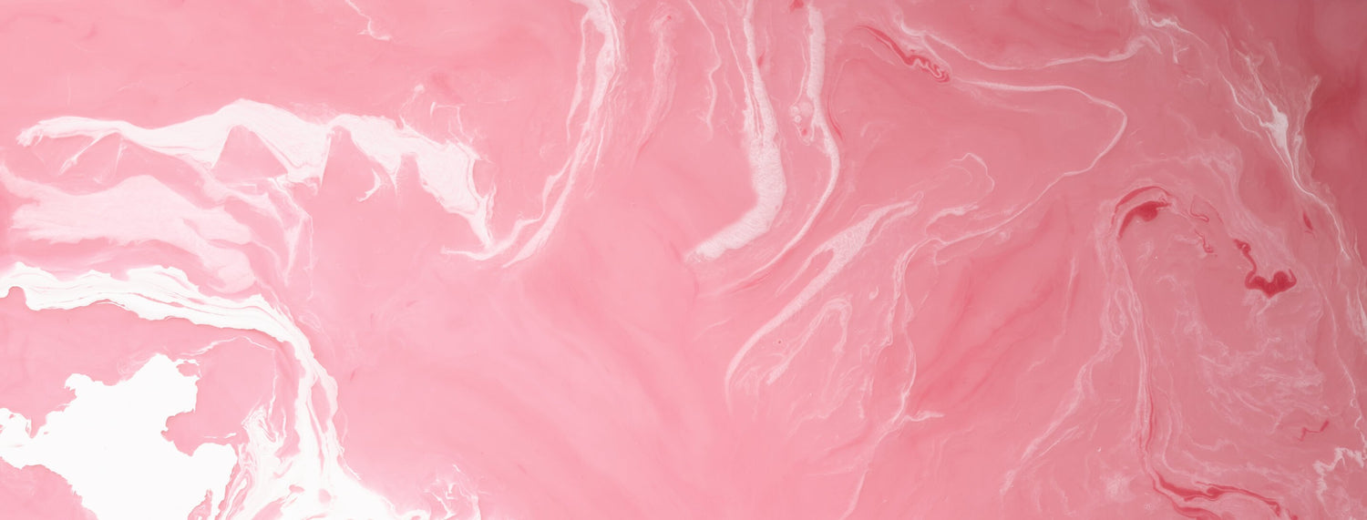 A pink liquid with White swirls 