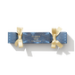 Blue cracker with golden ribbon wrapped around it, the fragrance shows 'Honey Oud'