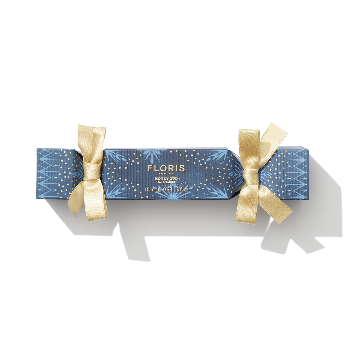 Blue cracker with golden ribbon wrapped around it, the fragrance shows 'Honey Oud'