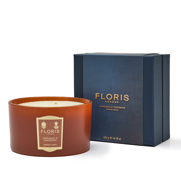 A limited-edition Floris London Cinnamon & Tangerine Deluxe Three Wick Candle beside its blue box packaging.