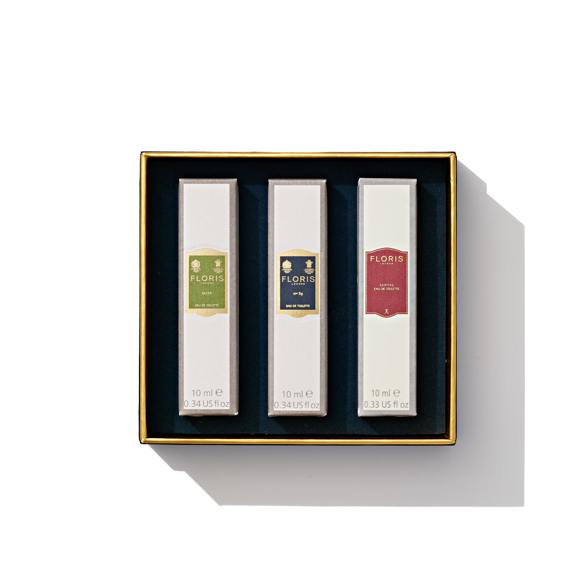 Introducing the Perfumer's Trilogy: For Him by Floris London, featuring a trio of British men's fragrances, each in distinctively colored elegant Floris boxes and presented in a refined black gift box with gold details—ideal for the festive season.
