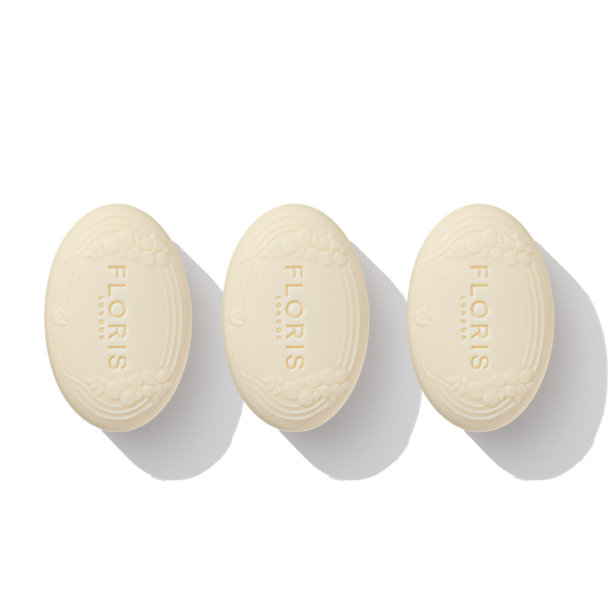 Three oval bars from the "Soap Collection | For Her" by Floris London are arranged in a row on a white background, showcasing their floral elegance and embossed branding.