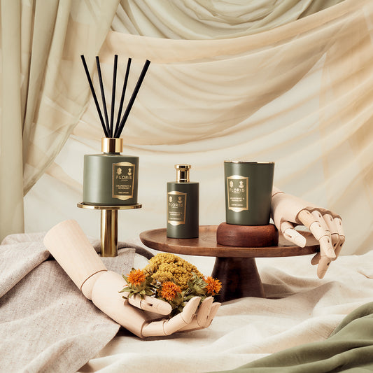 Floris London's Grapefruit & Rosemary Reed Diffuser 200ml with a fabric-draped background and floral wooden accents.