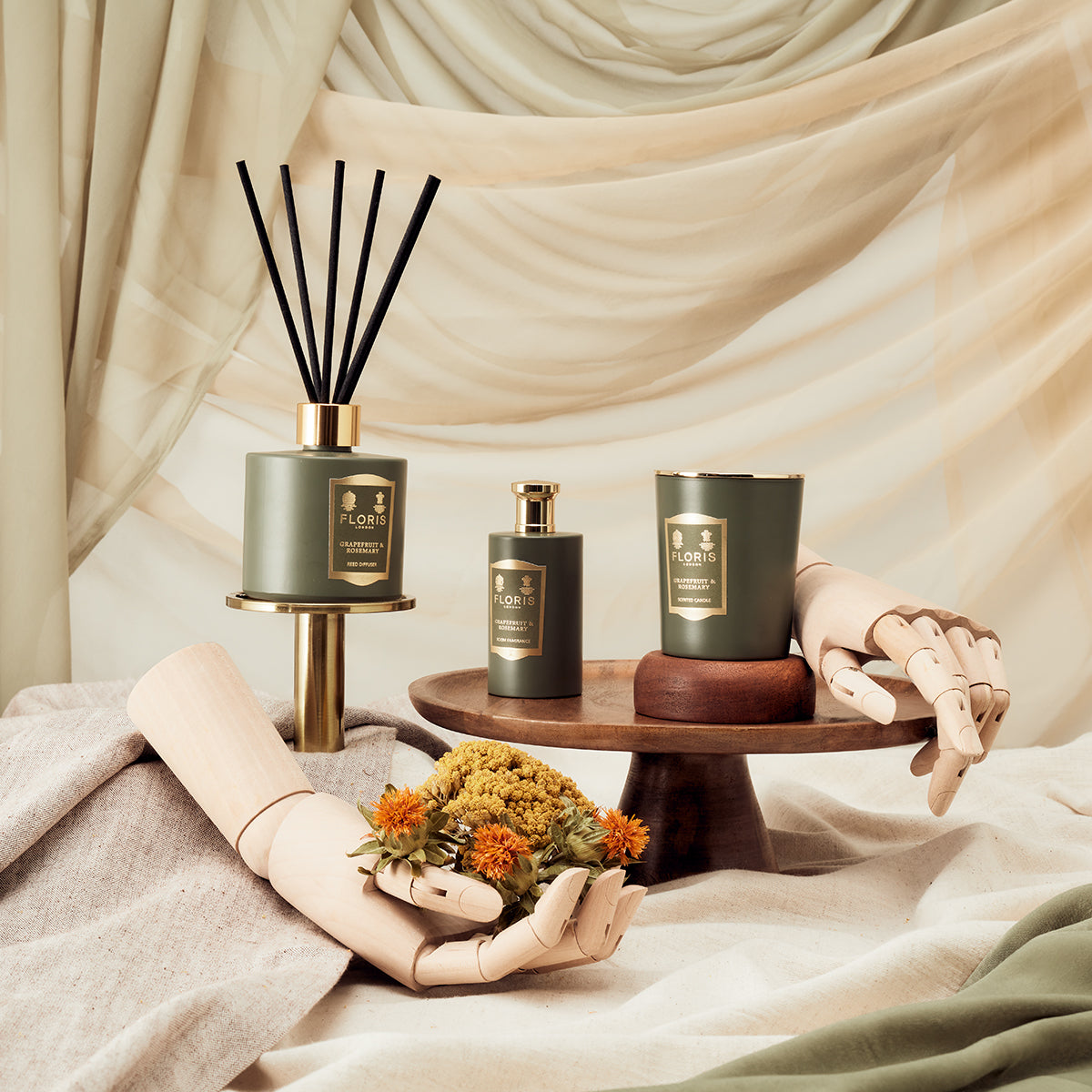 Floris London's Grapefruit & Rosemary Reed Diffuser 200ml with a fabric-draped background and floral wooden accents.