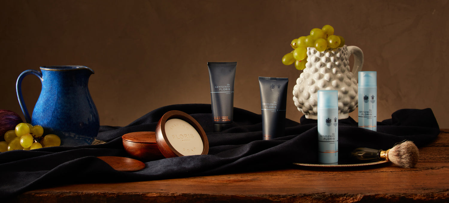 A brown wooden table with a range of Floris London Grooming products