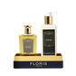 Floris London UK's Sweet Lux | Honey Oud Duo, featuring Eau de Parfum and Body Moisturiser, comes in luxe black and gold packaging on a matching tray.