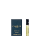 A 2 ml spray vial of Floris London Honey Oud - Eau de Parfum sits beside its black and gold box, both labeled with the brand and fragrance name.