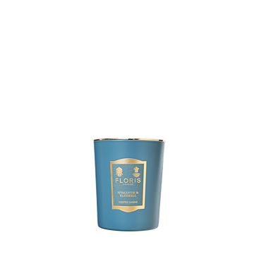 Floris London's "Hyacinth & Bluebell" 175g candle, with gold accents, delivers a refreshing green floral fragrance for a richly scented atmosphere.