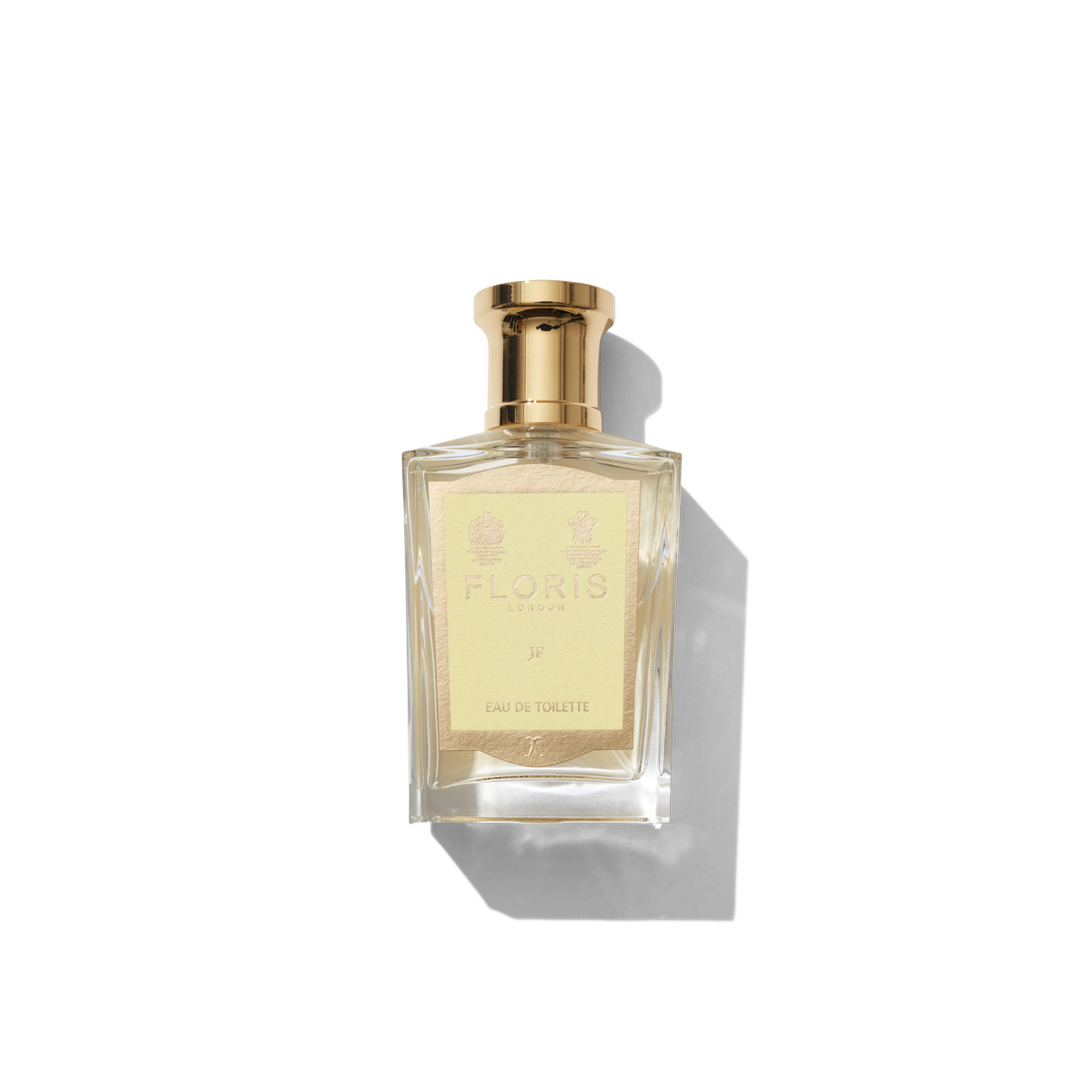 Medium Clear glass bottle with gold spray top and yellow JF label